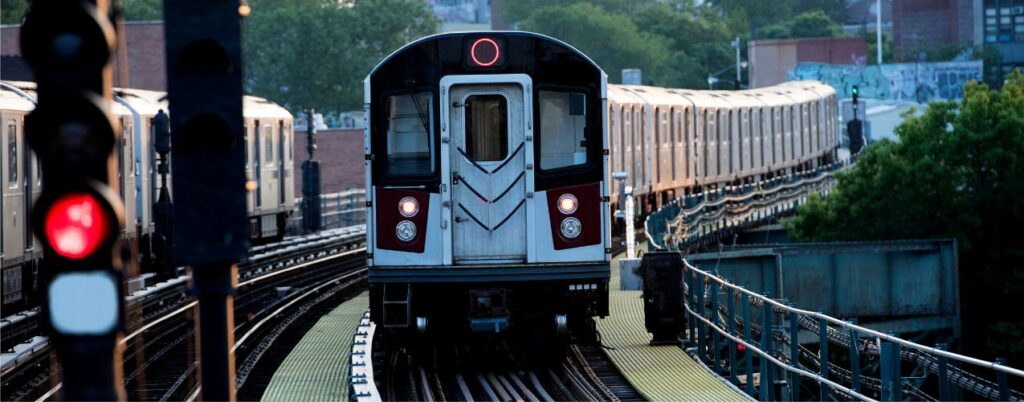 Rail cyber security New York city metro train rolling down some overhead tracks